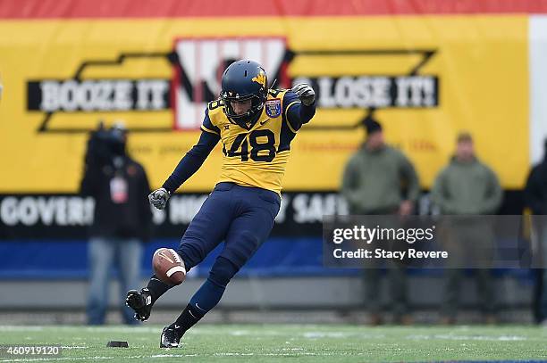 Michael Molinari of the West Virginia Mountaineers kicks the ball to the Texas A&M Aggies during the 56th annual Autozone Liberty Bowl at Liberty...