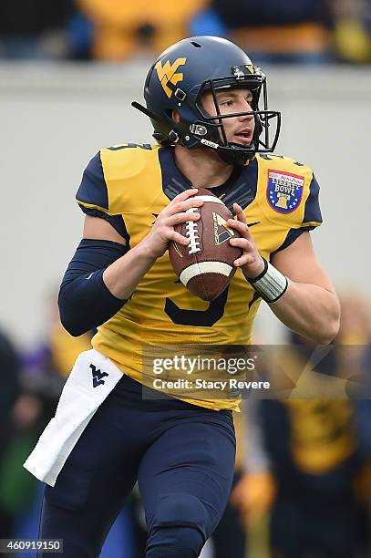 Skyler Howard of the West Virginia Mountaineers looks to pass against the Texas A&M Aggies during the 56th annual Autozone Liberty Bowl at Liberty...