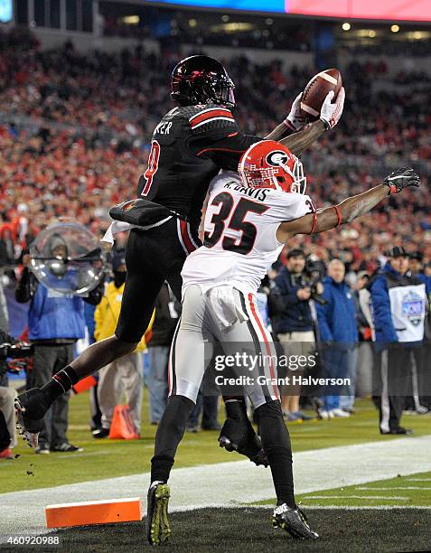 DeVante Parker of the Louisville Cardinals makes a touchdown catch over Aaron Davis of the Georgia Bulldogs during the Belk Bowl at Bank of America...