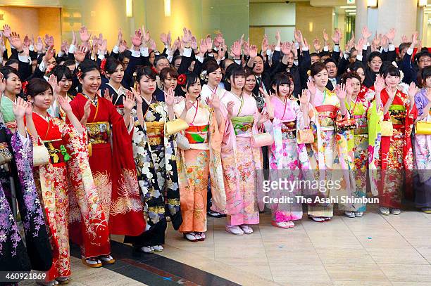 Employees wearing kimono make banzai cheers during a opening ceremony of the first trading day of the year at Osaka Securities Exchange on January 6,...