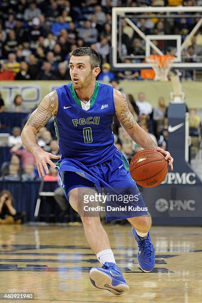 Brett Comer of the Florida Gulf Coast Eagles brings the ball up court against the Pittsburgh Panthers at Petersen Events Center on December 30, 2014...