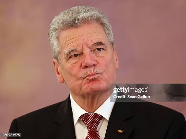 German President Joachim Gauck welcomes children Epiphany carolers dressed as the Three Kings at Schloss Bellevue palace on January 6, 2014 in...