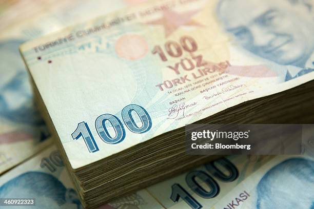 Pile of 100 denomination Turkish lira banknotes sit in this arranged photograph in Istanbul, Turkey, on Sunday, Jan. 5, 2014. The Turkish lira is...