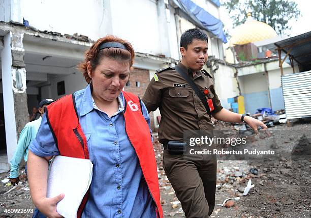 Andrea Waldeck of Britain is escorted to a hearing for drug trafficking charges on January 6, 2014 in Surabaya, Indonesia. Prosecutors are seeking a...