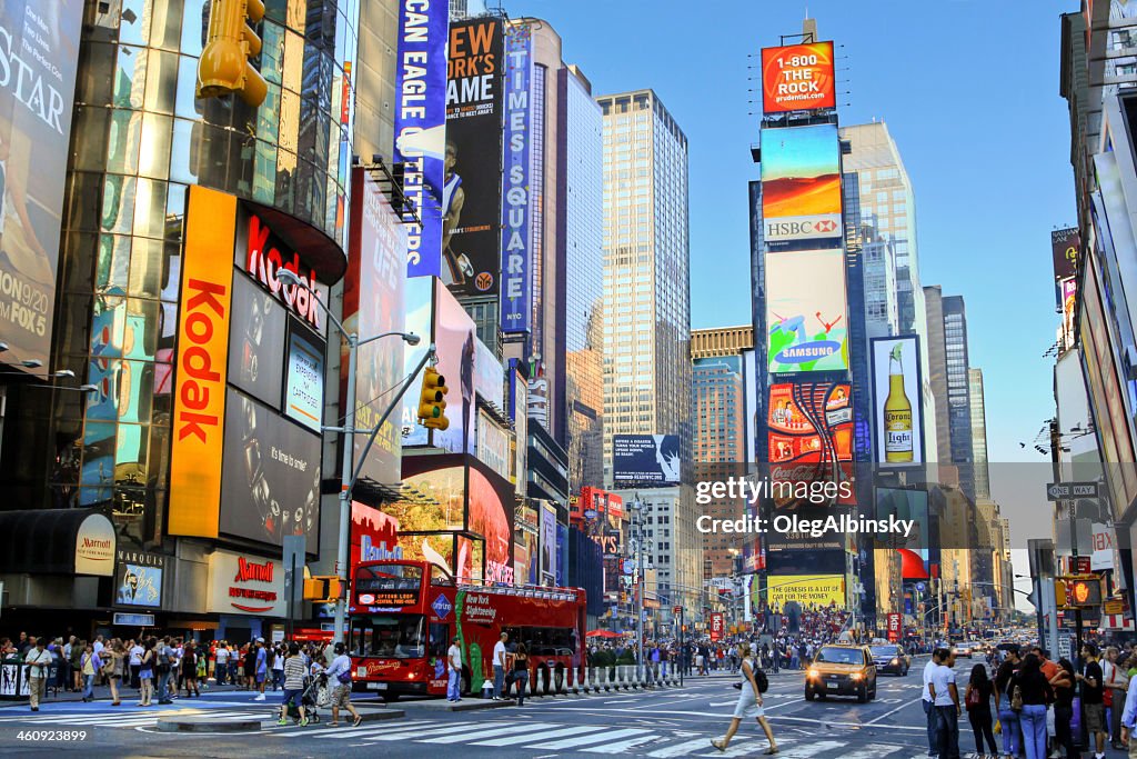 Times Square, Manhattan, New York City, lit by evening sun.