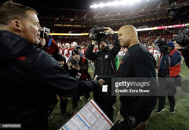 Head coach David Shaw of the Stanford Cardinal shakes hands with head coach Randy Edsall of the Maryland Terrapins after the Cardinal defeated the...