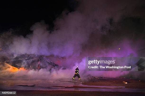 Firefighters worked to put out fires that spanned the town after an announcement that Ferguson police officer Darren Wilson will not be indicted in...