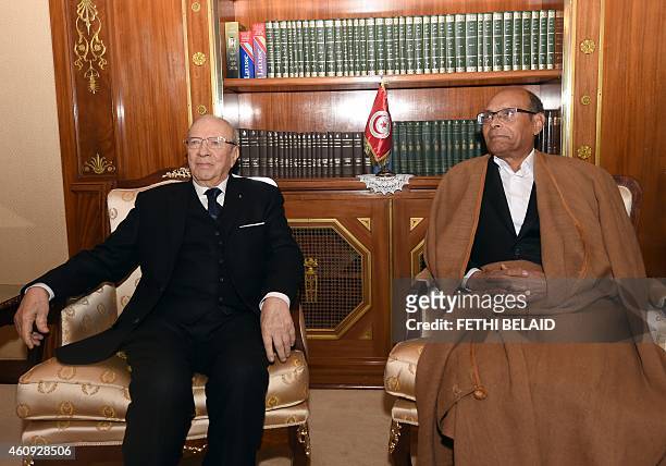 Tunisian newly-elected President Beji Caid Essebsi meets with his predecessor Moncef Marzouki during a handover ceremony on December 31, 2014 at the...