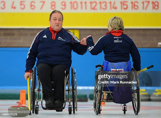 Tom Killin fist pumps with Angela Malone during the ParalympicsGB Wheelchair Curling Training Day on 6th January 2014 in Hamilton, Scotland.