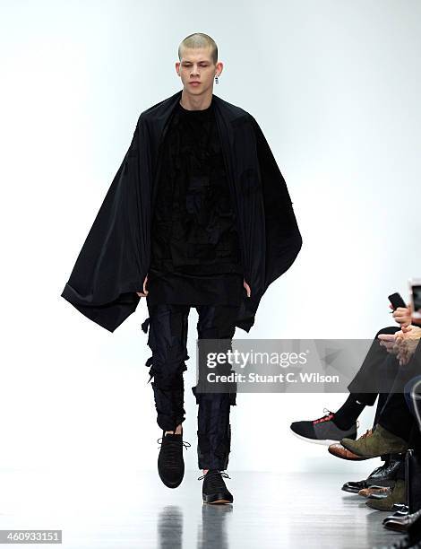 Model walks the runway at the Matthew Miller show during The London Collections: Men Autumn/Winter 2014 on January 6, 2014 in London, England.