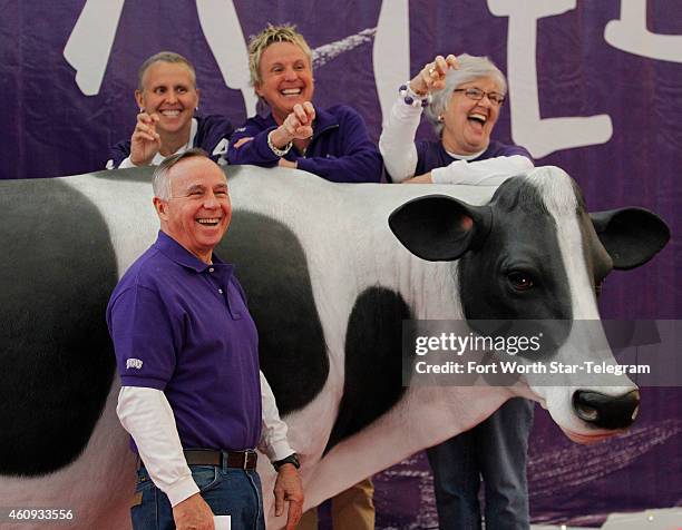 Ron Aebersold poses with his family, daughters Kathy and Ashley and wife Jackie with the Chick fil A cow at Fan Fest before TCU plays the University...