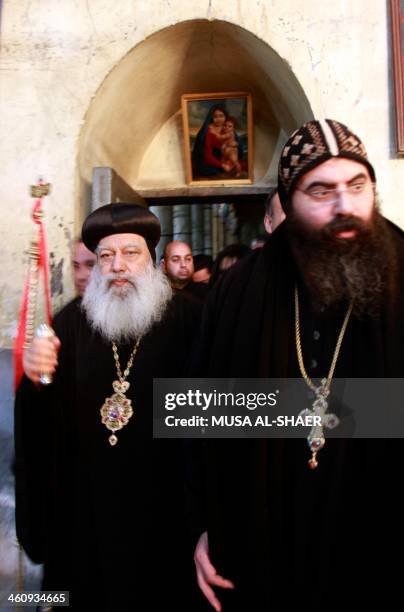 Archbishop Anba Abraham the Coptic Orthodox Metropolitan Archbishop of Jerusalem and clergy, walk through the central nave of the Church of the...