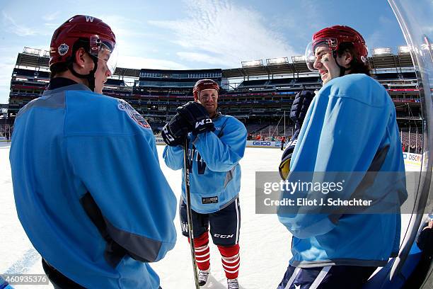 Michael Latta, Jason Chimera and Tom Wilson of the Washington Capitals take a break during practice day prior to the 2015 Bridgestone NHL Winter...