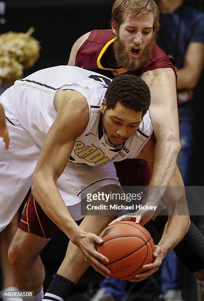 Elliott Eliason of the Minnesota Golden Gophers reaches over the back of A.J. Hammons of the Purdue Boilermakers for the ball at Mackey Arena on...