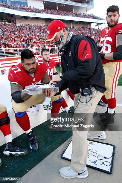 Offensive Line Coach Mike Solari of the San Francisco 49ers talks with Mike Iupati during the game against the Arizona Cardinals at Levi Stadium on...