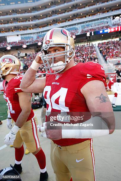 Justin Smith of the San Francisco 49ers stands on the sideline during the game against the Arizona Cardinals at Levi Stadium on December 28, 2014 in...