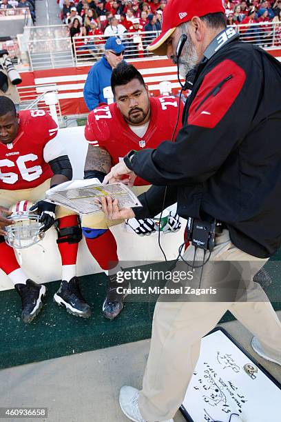 Offensive Line Coach Mike Solari of the San Francisco 49ers talks with Mike Iupati during the game against the Arizona Cardinals at Levi Stadium on...