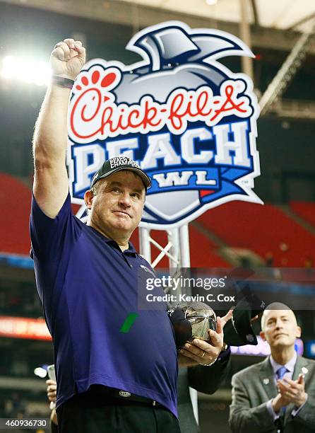 Head coach Gary Patterson of the TCU Horned Frogs celebrates with the trophy after their 42 to 3 win over the Ole Miss Rebels during the Chik-fil-A...