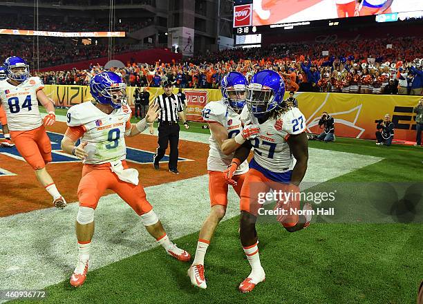 Jay Ajayi, Grant Hedrick and Thomas Sperbeck of the Boise State Broncos celebrate a 56 yard touchdown during the first quarter against the Arizona...