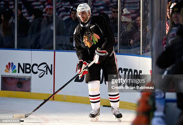 Michal Rozsival of the Chicago Blackhawks skates the puck into the sunlight during practice day prior to the 2015 Bridgestone NHL Winter Classic on...