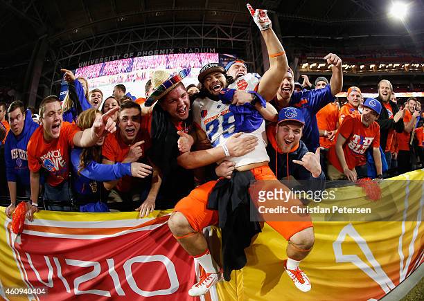 Linebacker Christopher Santini of the Boise State Broncos celebrates with fans after defeating the Arizona Wildcats 38-30 to win the Vizio Fiesta...