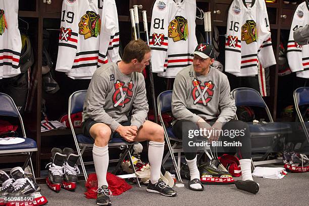 Jonathan Toews and Marian Hossa of the Chicago Blackhawks sit in the locker room prior to the NHL Winter Classic practice on December 31, 2014 in...