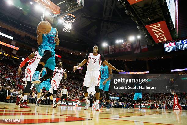 Kemba Walker of the Charlotte Hornets looks to pass under the basket against the Houston Rockets during their game at the Toyota Center on December...
