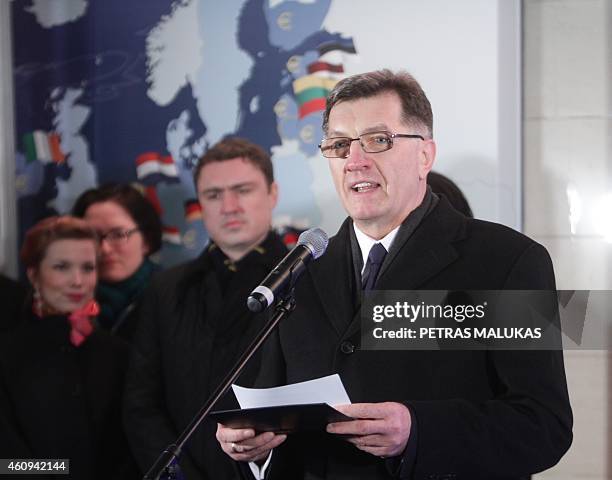 Lithuanian Prime Minister Algirdas Butkevicius withdraws euros from a bank machine during a ceremony January 1, 2015 in Vilnius. Lithuania switched...