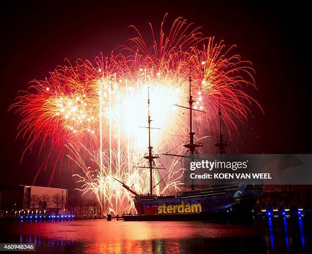 Fireworks erupt above the Scheepvaart Museum, in Amsterdam to mark the arrival of the new year early on January 1, 2015. AFP PHOTO / ANP KOEN VAN...