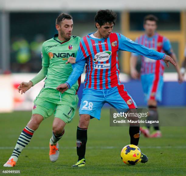 Pablo Barrientos of Catania competes for the ball with Francesco Della Rocca of Bologna during the Serie A match between Calcio Catania and Bologna...