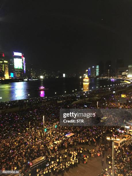 Rescuers help victims of a stampede by New Year revellers on Shanghai's historic riverfront on January 1, 2015. A stampede by New Year's revellers in...