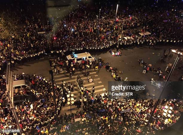 Rescuers help victims of a stampede by New Year revellers on Shanghai's historic riverfront on January 1, 2015. A stampede by New Year's revellers in...