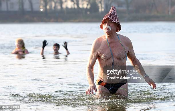 Swimmers wade in the cold waters of Orankesee lake during its New Year's swimming event on January 1, 2015 in Berlin, Germany. A local swimmers'...