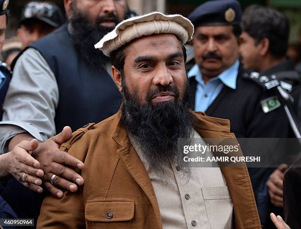 Pakistani security personnel escort Zaki-ur-Rehman Lakhvi , alleged mastermind of the 2008 Mumbai attacks, leaves the court after a hearing in...