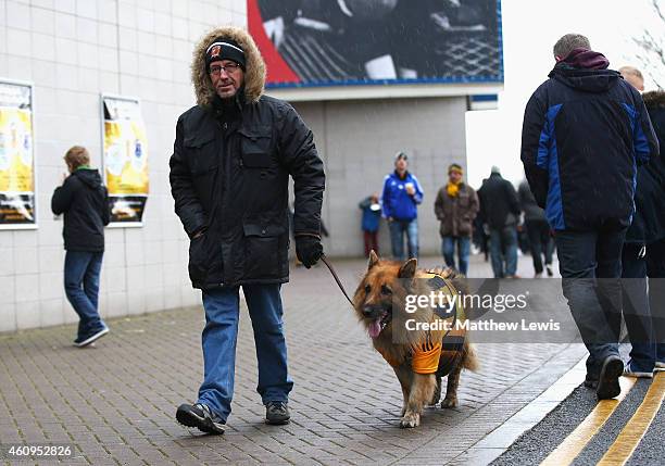 Hull City fan walks his dog outside the ground prior to the Barclays Premier League match between Hull City and Everton at KC Stadium on January 1,...