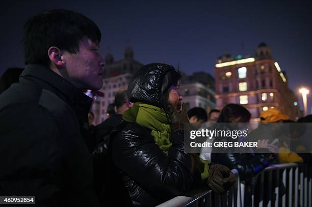 Bystanders gather at the site of a New Year's Eve stampede at The Bund in Shanghai on January 1, 2015. The New Year's stampede on Shanghai's historic...