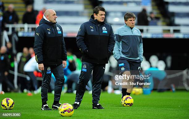 Newcastle United caretaker coach John Carver chats with assistant Steve Stone as coach Peter Beardsley looks on before the Barclays Premier League...
