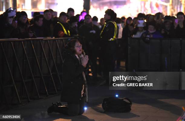 Woman weeps at the site of a New Year's Eve stampede at The Bund in Shanghai on January 1, 2015. The New Year's stampede on Shanghai's historic...