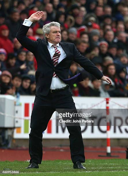 Manager Mark Hughes of Stoke City watches from the touchline during the Barclays Premier League match between Stoke City and Manchester United at...