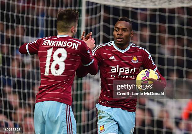 Diafra Sakho of West Ham United celebrates with Carl Jenkinson as he scores their first goal during the Barclays Premier League match between West...