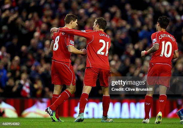 Steven Gerrard of Liverpool is congratulated by teammates Lucas Leiva of Liverpool and Philippe Coutinho of Liverpool after scoring the opening goal...