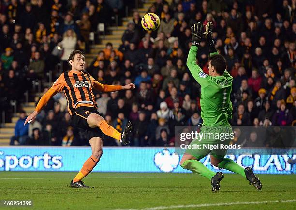 Nikica Jelavic of Hull City touches the ball over Joel Robles of Everton for his team's second goal during the Barclays Premier League match between...