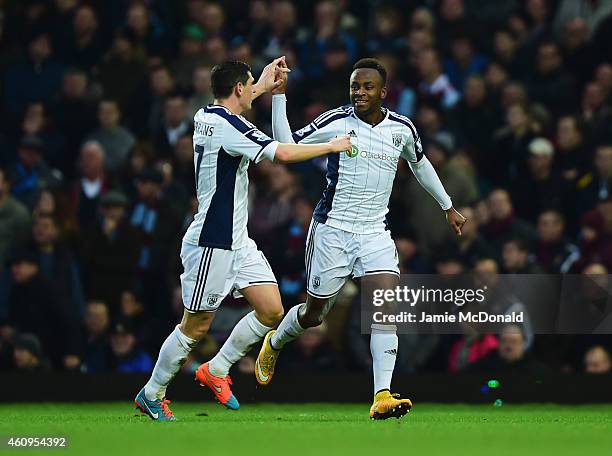 Saido Berahino of West Bromwich Albion celebrates with Graham Dorrans as he scores their first goal during the Barclays Premier League match between...