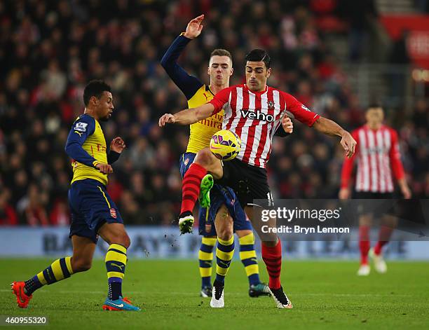 Graziano Pelle of Southampton battlles with Calum Chambers and Francis Coquelin of Arsenal during the Barclays Premier League match between...