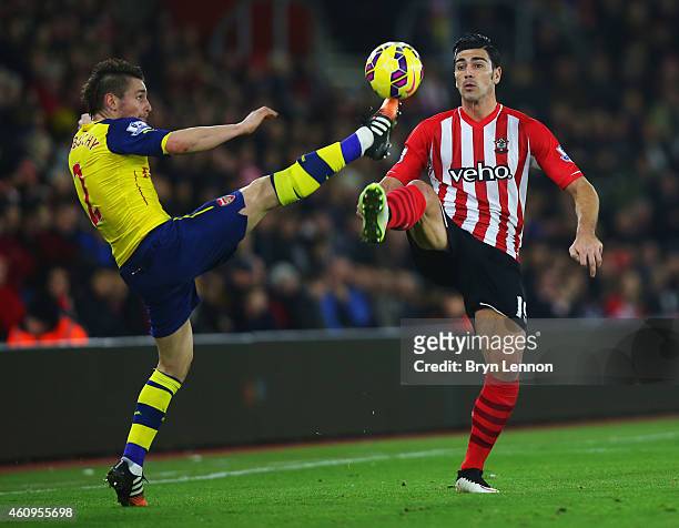 Graziano Pelle of Southampton chalenges Mathieu Debuchy of Arsenal during the Barclays Premier League match between Southampton and Arsenal at St...