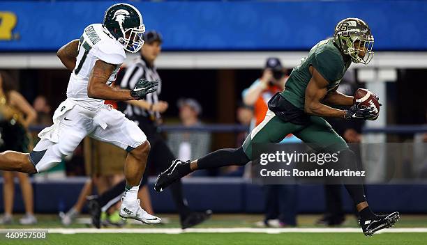 Cannon of the Baylor Bears makes the catch for a touchdown as Kurtis Drummond of the Michigan State Spartans defends during the first half of the...