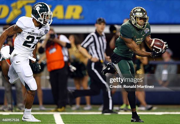 Cannon of the Baylor Bears makes the catch for a touchdown as Kurtis Drummond of the Michigan State Spartans defends during the first half of the...