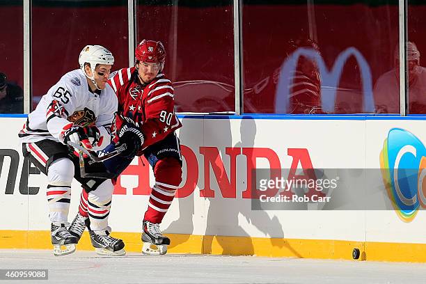 Andrew Shaw of the Chicago Blackhawks battles for the puck with Marcus Johansson of the Washington Capitals during the first period of the 2015 NHL...