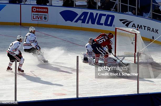 Eric Fehr of the Washington Capitals slides a shot past goaltender Corey Crawford of the Chicago Blackhawks in the first period during the 2015...