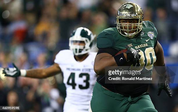 LaQuan McGowan of the Baylor Bears runs for a touchdown against the Michigan State Spartans during the second half of the Goodyear Cotton Bowl...